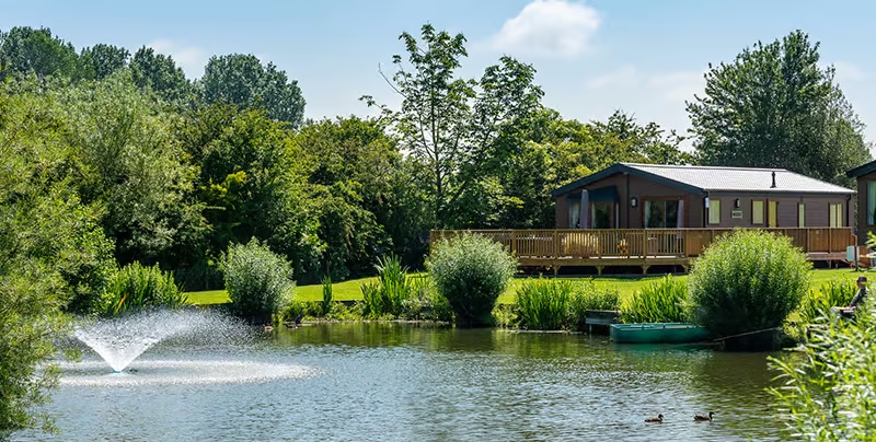 lodge over a lake with a water fountain